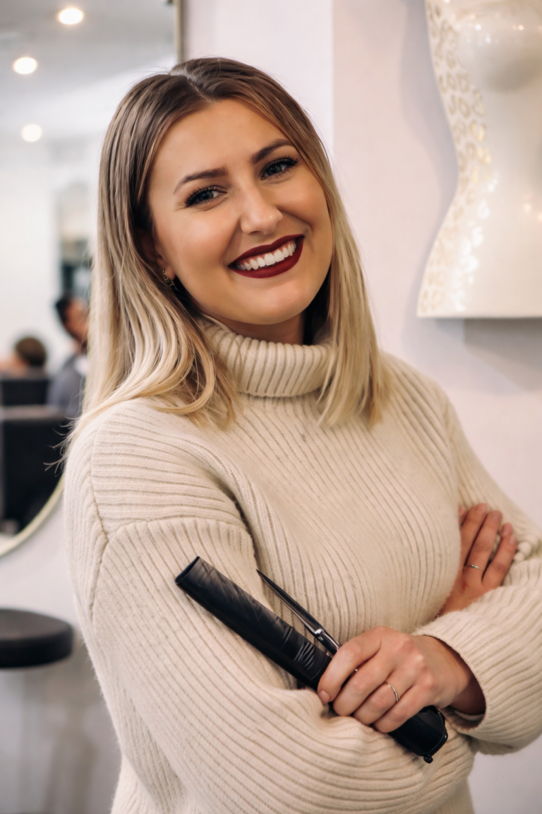 Smiling stylist with flat iron - Yeovil Salon